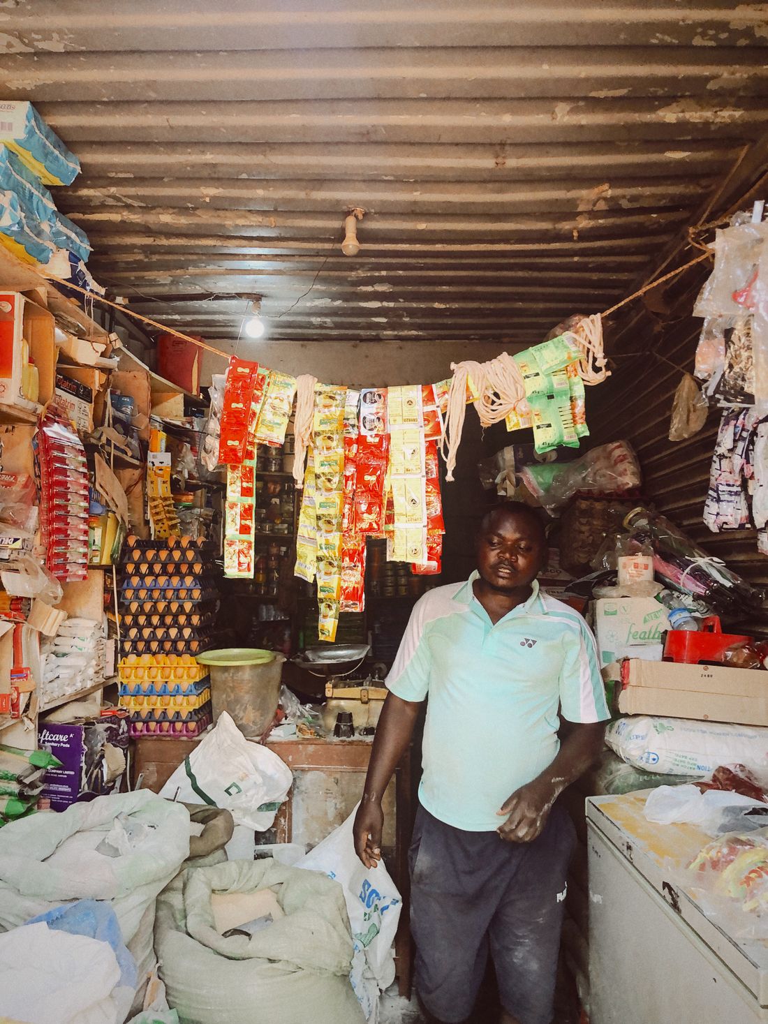 A Nigerian shop owner in his provisions store